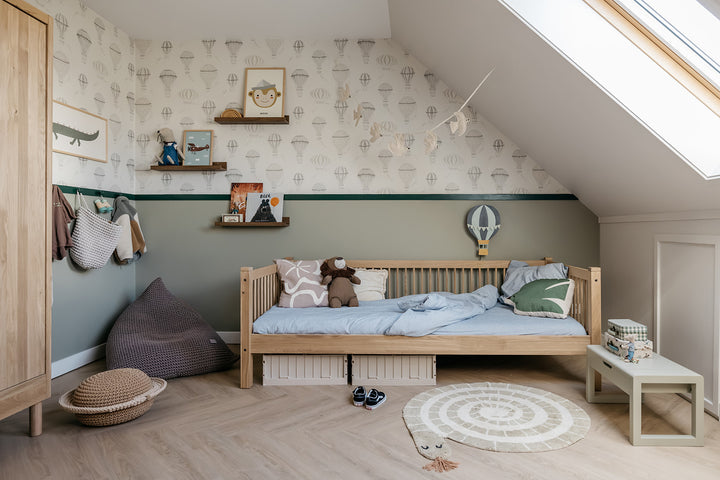Children's bedroom with wooden bed, toys, and decorative elements.