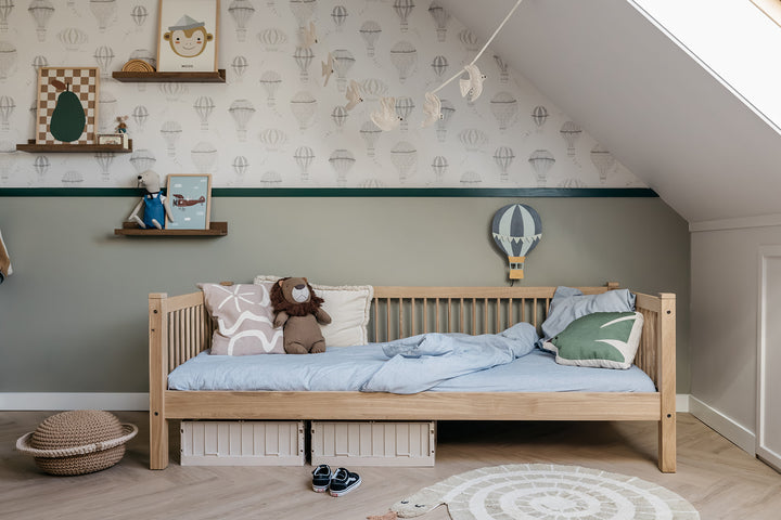 Children's bedroom with wooden bed, toys, and decorative elements.