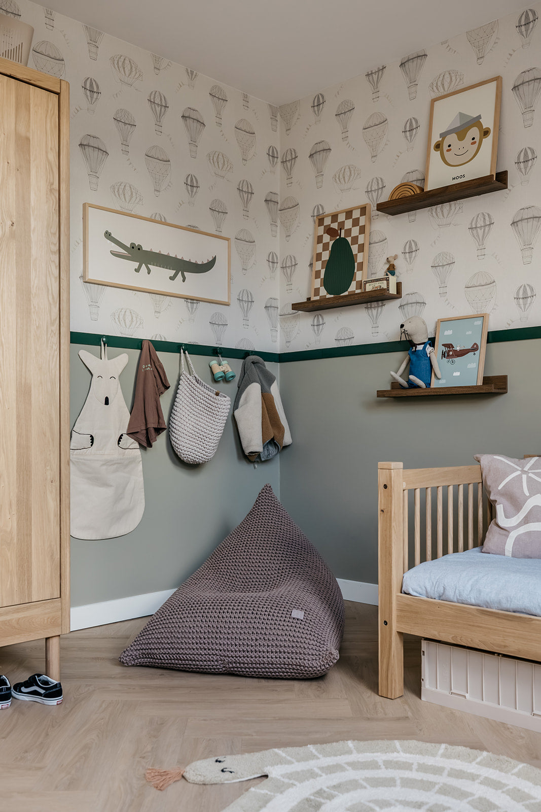 Children's room with wooden furniture, bean bag, and wall decorations.