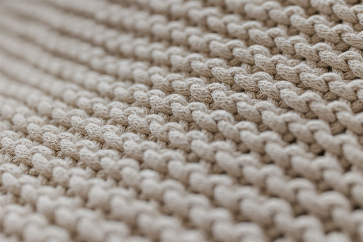 Close-up of beige woven fabric texture
