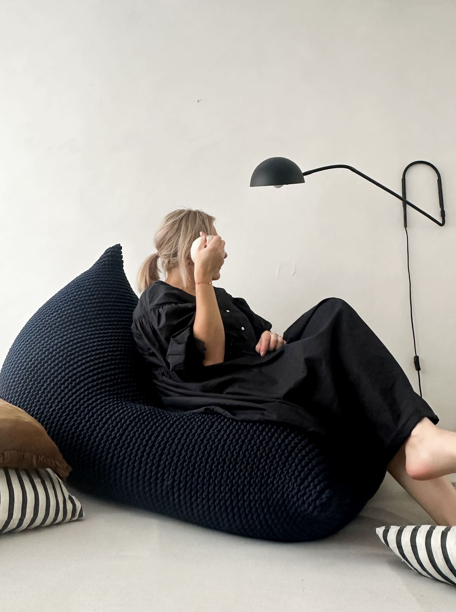 a lady sitting on a bean bag chair in the deep blue colour