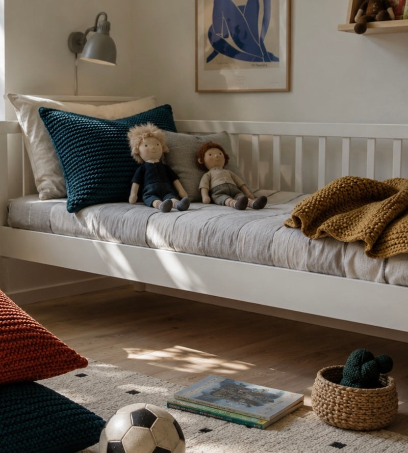 Children's room with a white bed, toys, and decorative items.