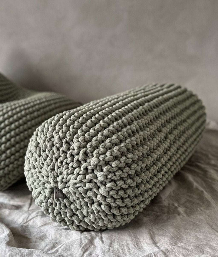 Chunky knitted bolster footrest | LIGHT OLIVE - Zuri House