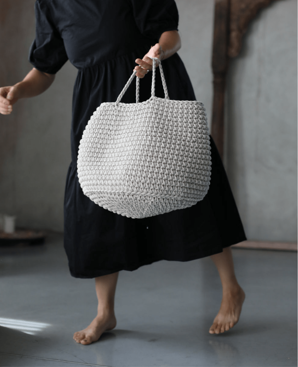 Neutral-toned crochet storage basket in oatmeal cotton, perfect for living rooms, bedrooms or shelves