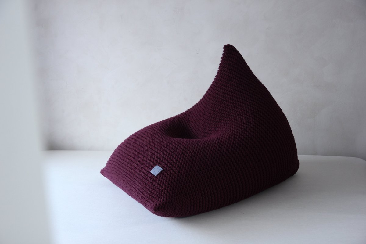 Handcrafted aubergine cotton bean bag showcasing sculptural silhouette