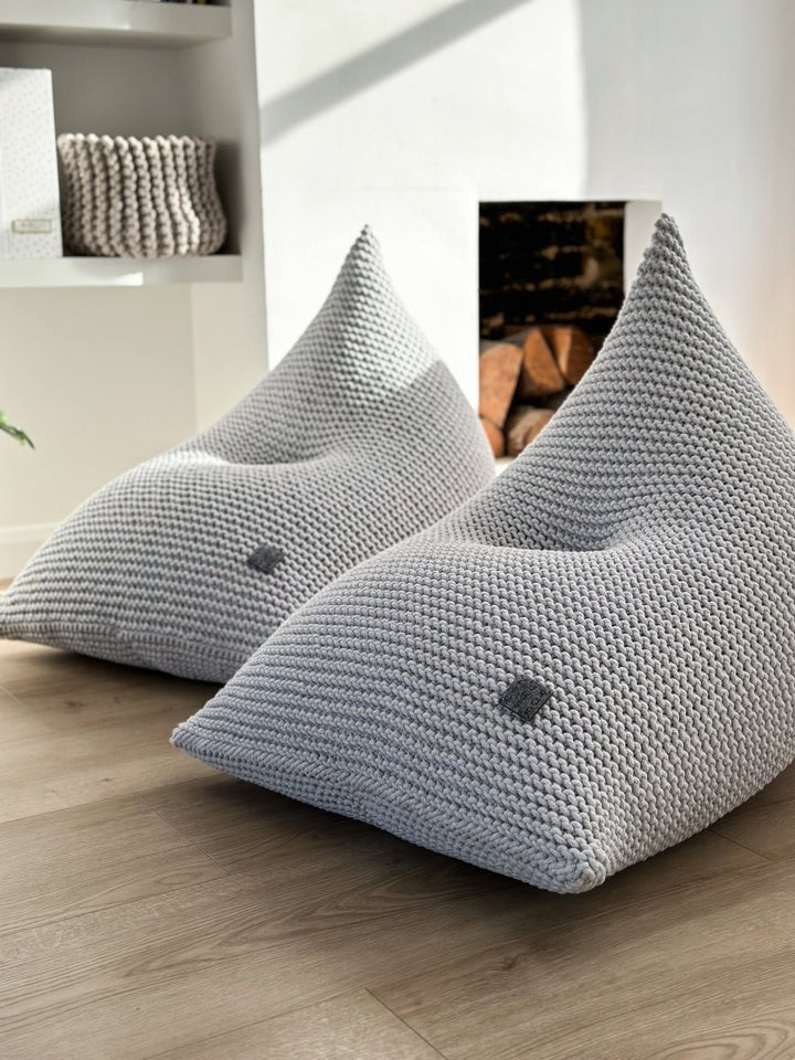 Close-up of a light grey chunky knit bean bag with soft cotton texture