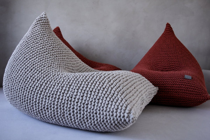 Close-up of an oatmeal chunky knit bean bag with visible cotton cord texture