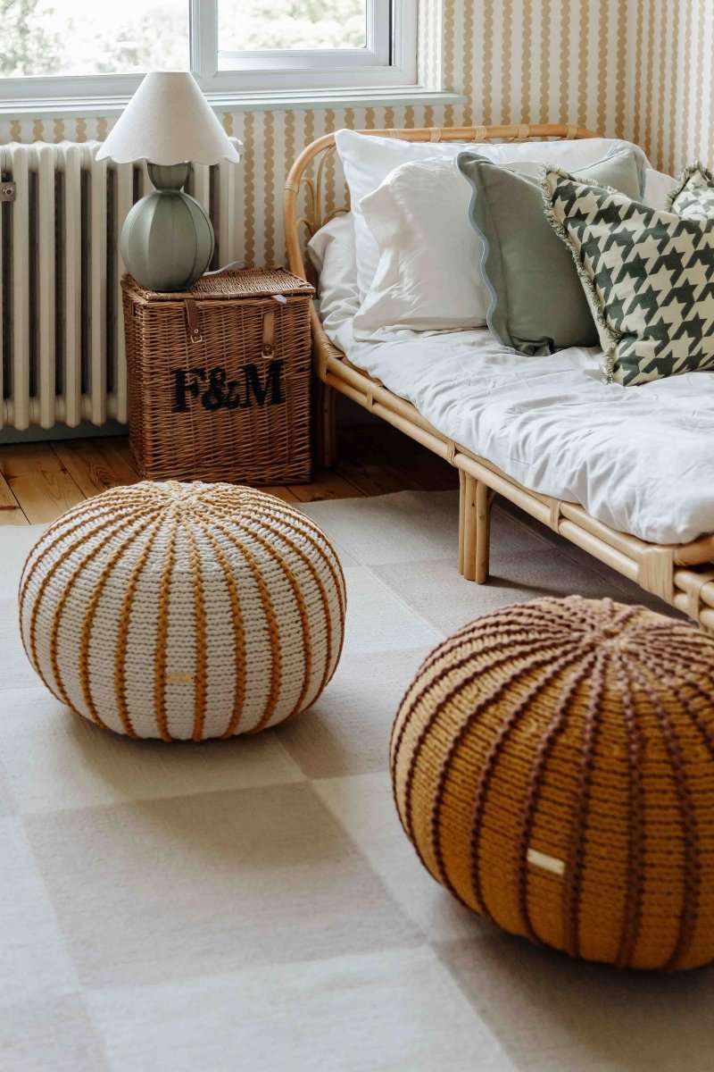 Mustard and ivory striped Ziggy pouffe in a neutral nursery