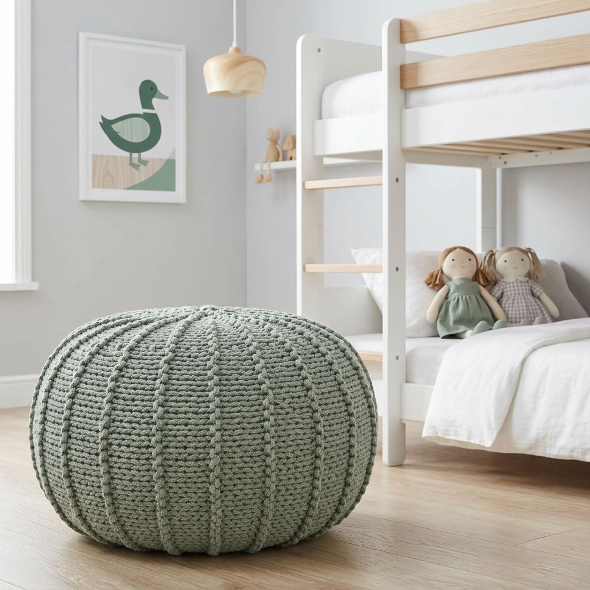 Green knitted pouf in a child's bedroom with a bunk bed and wall art.