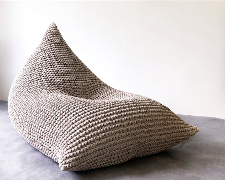 Beige cotton bean bag highlighting handcrafted knitting and organic form