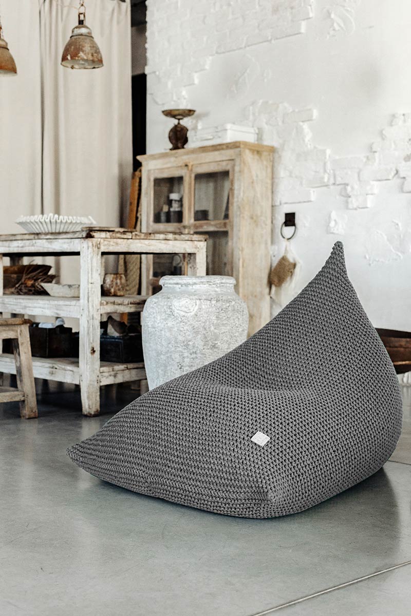 Soft dark grey knitted bean bag shown in a plain, minimal background
