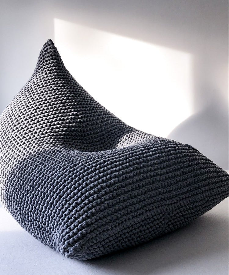 Close-up of a dark grey chunky knit bean bag with soft cotton texture
