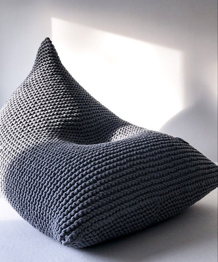 Close-up of a dark grey chunky knit bean bag with soft cotton texture