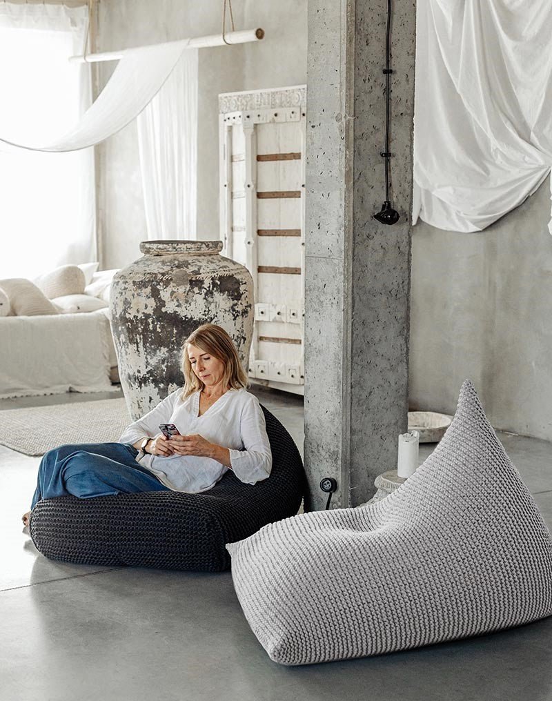 Textured light grey cotton knit bean bag displayed in soft, natural light