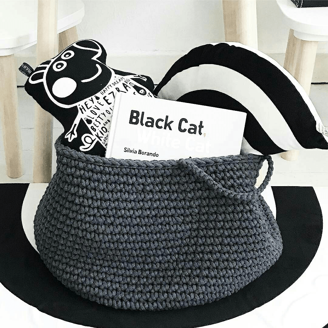 Handmade charcoal crochet basket filled with soft toys, perfect for children's room storage