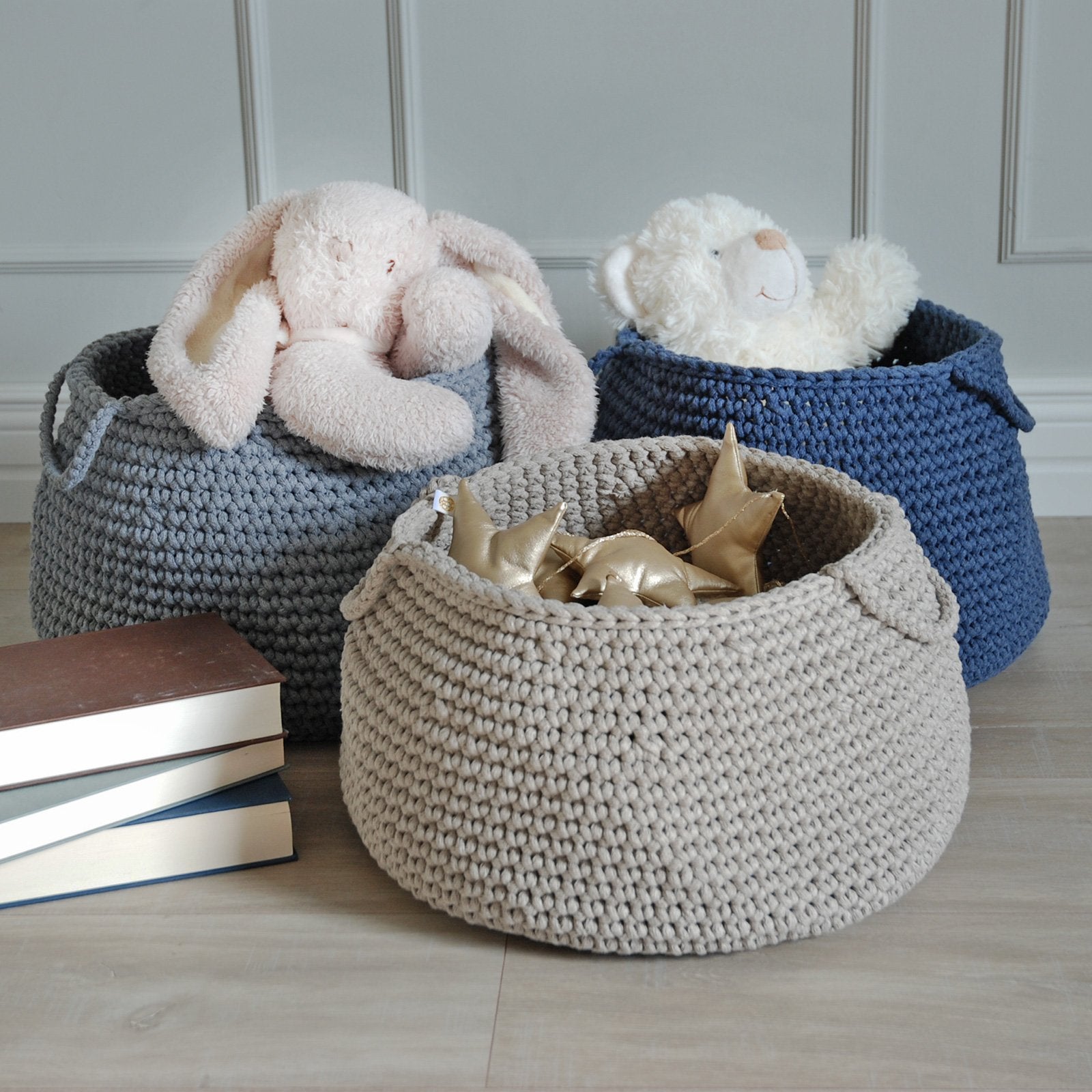 Blue cotton basket with handles, neatly storing soft toys in a modern kids’ room