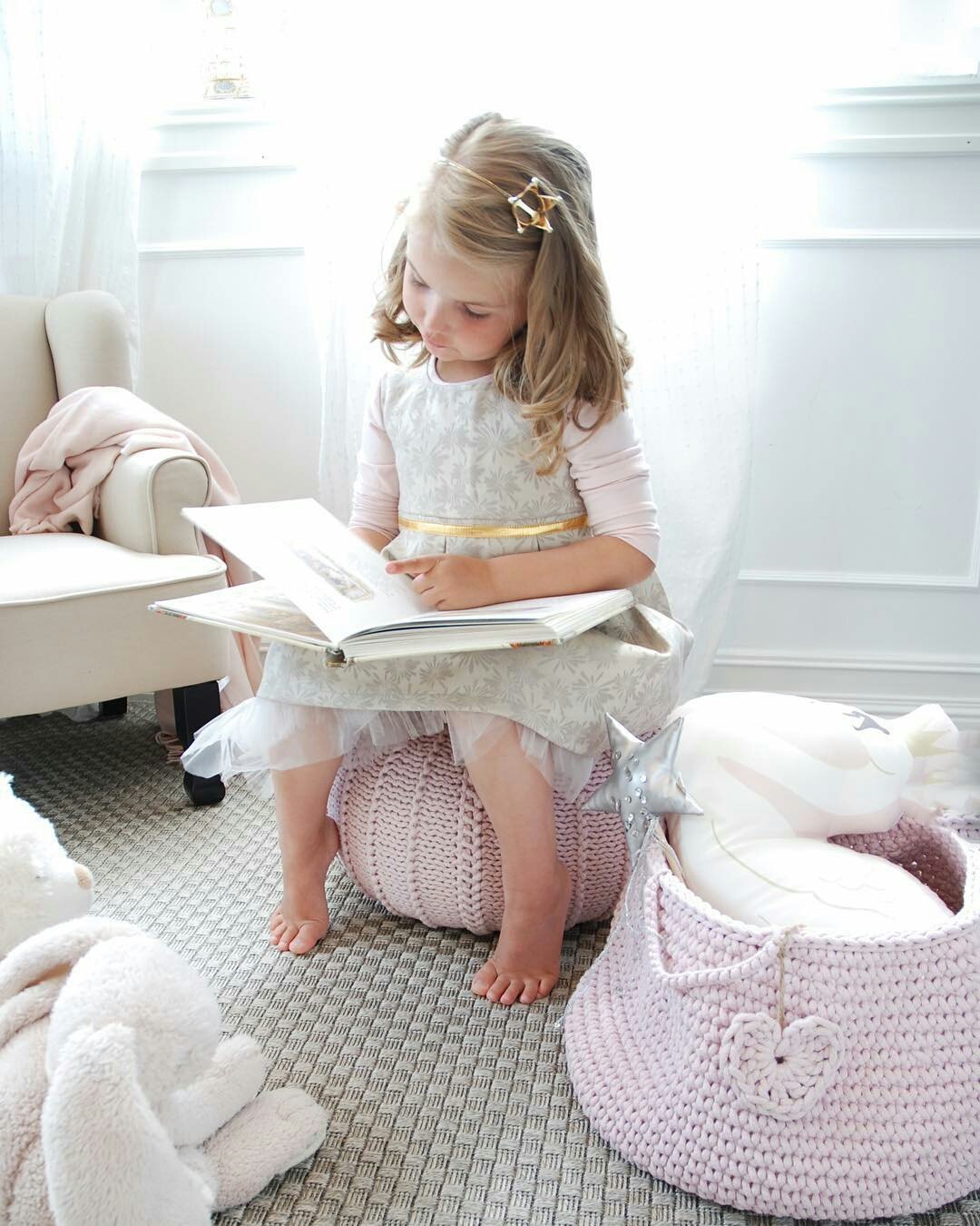 Handmade pink cotton basket holding plush animals and blocks in a baby’s room