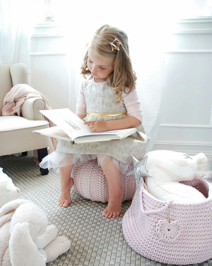 Handmade pink cotton basket holding plush animals and blocks in a baby’s room